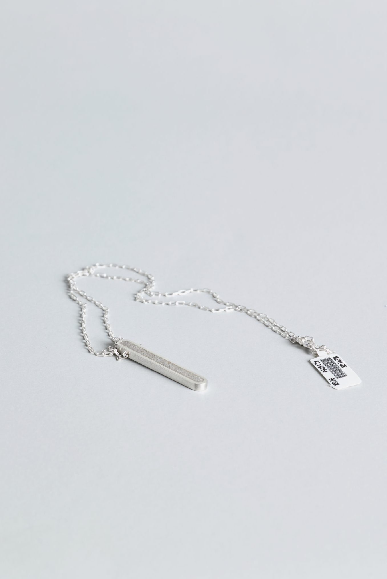 Arcil necklace – handcrafted concrete and silver minimalist architectural jewelry.