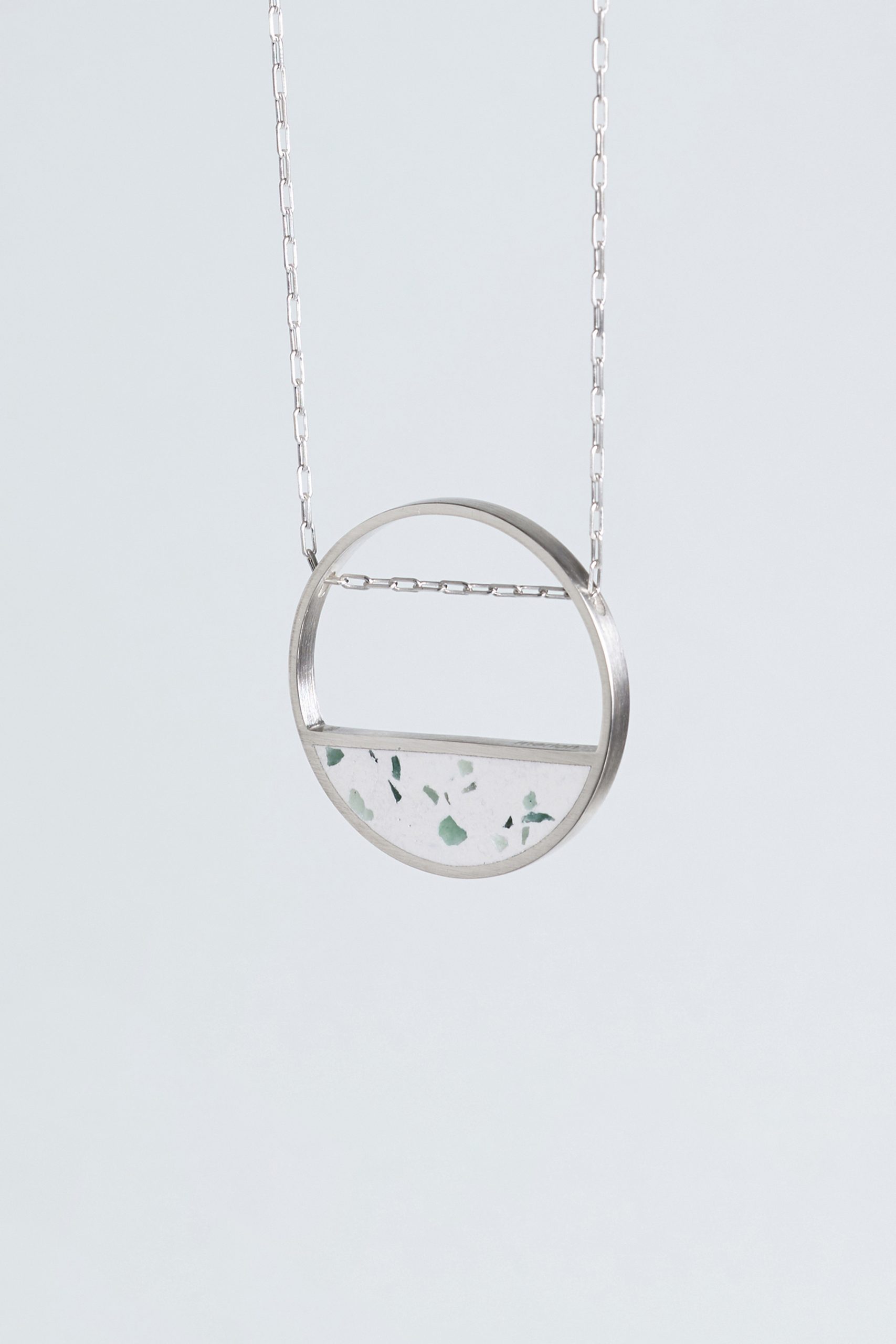 Hurne necklace – handcrafted concrete and silver minimalist architectural jewelry.