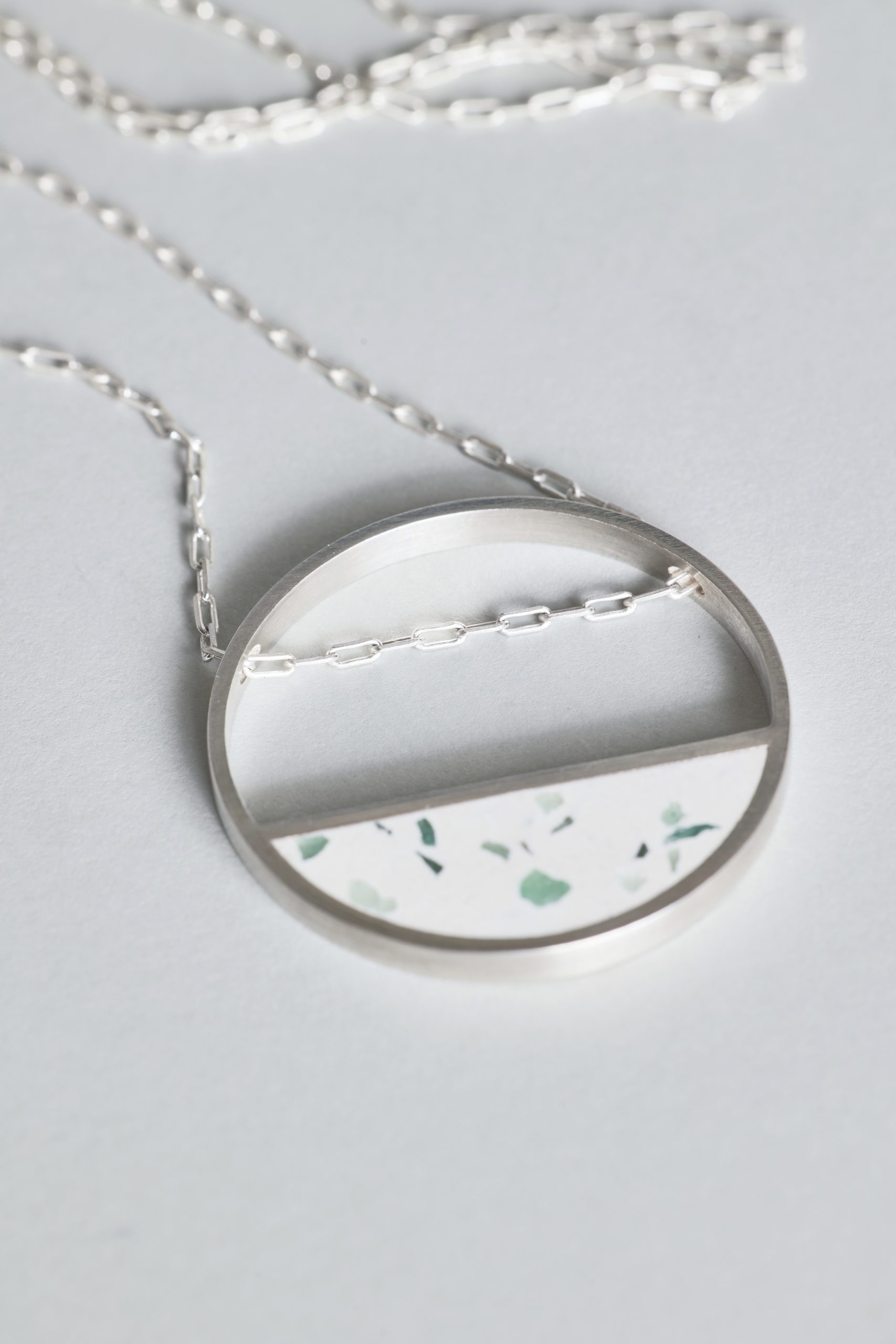 Hurne necklace – handcrafted concrete and silver minimalist architectural jewelry.