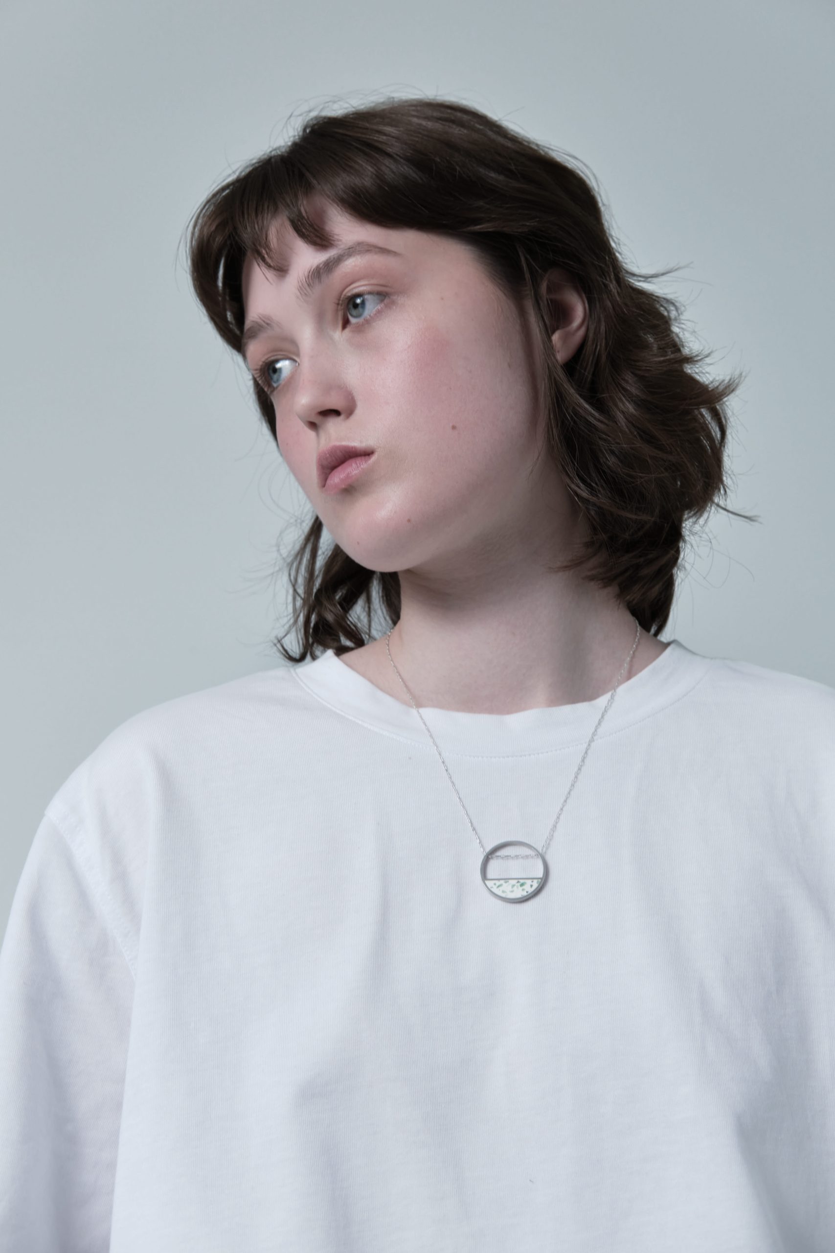 Hurne necklace – handcrafted concrete and silver minimalist architectural jewelry.