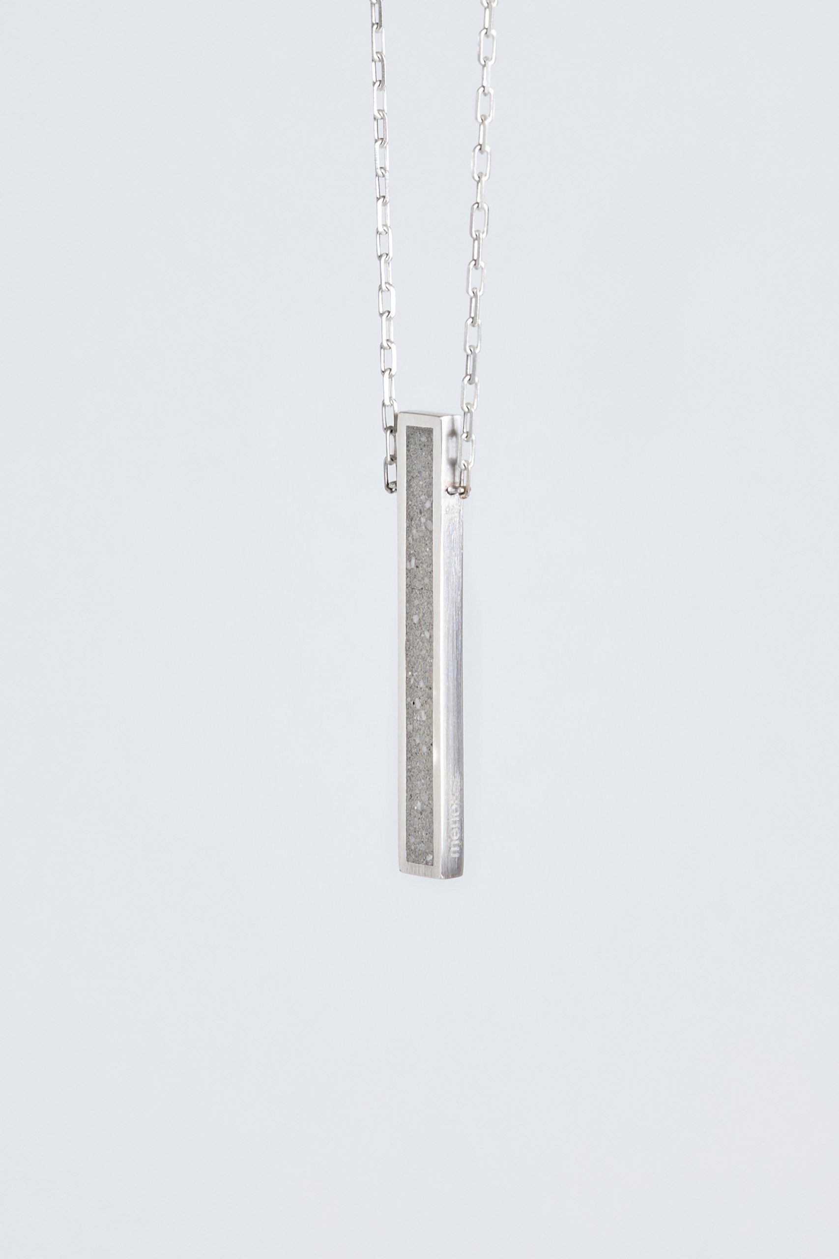 Lintour necklace – handcrafted concrete and silver minimalist architectural jewelry.