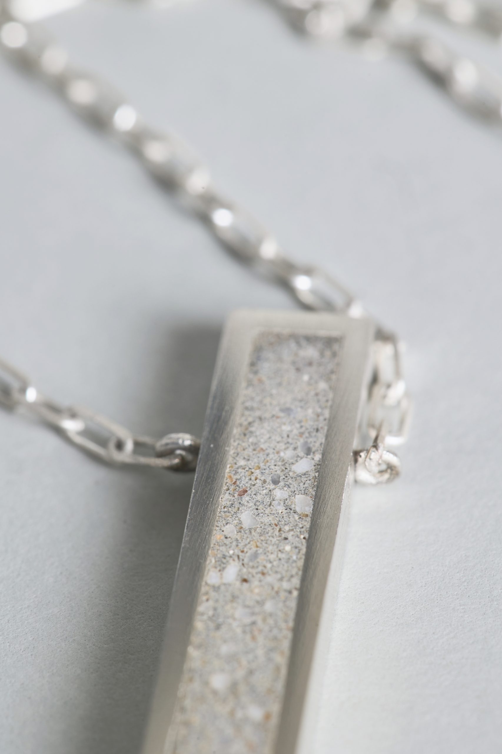 Lintour necklace – handcrafted concrete and silver minimalist architectural jewelry.