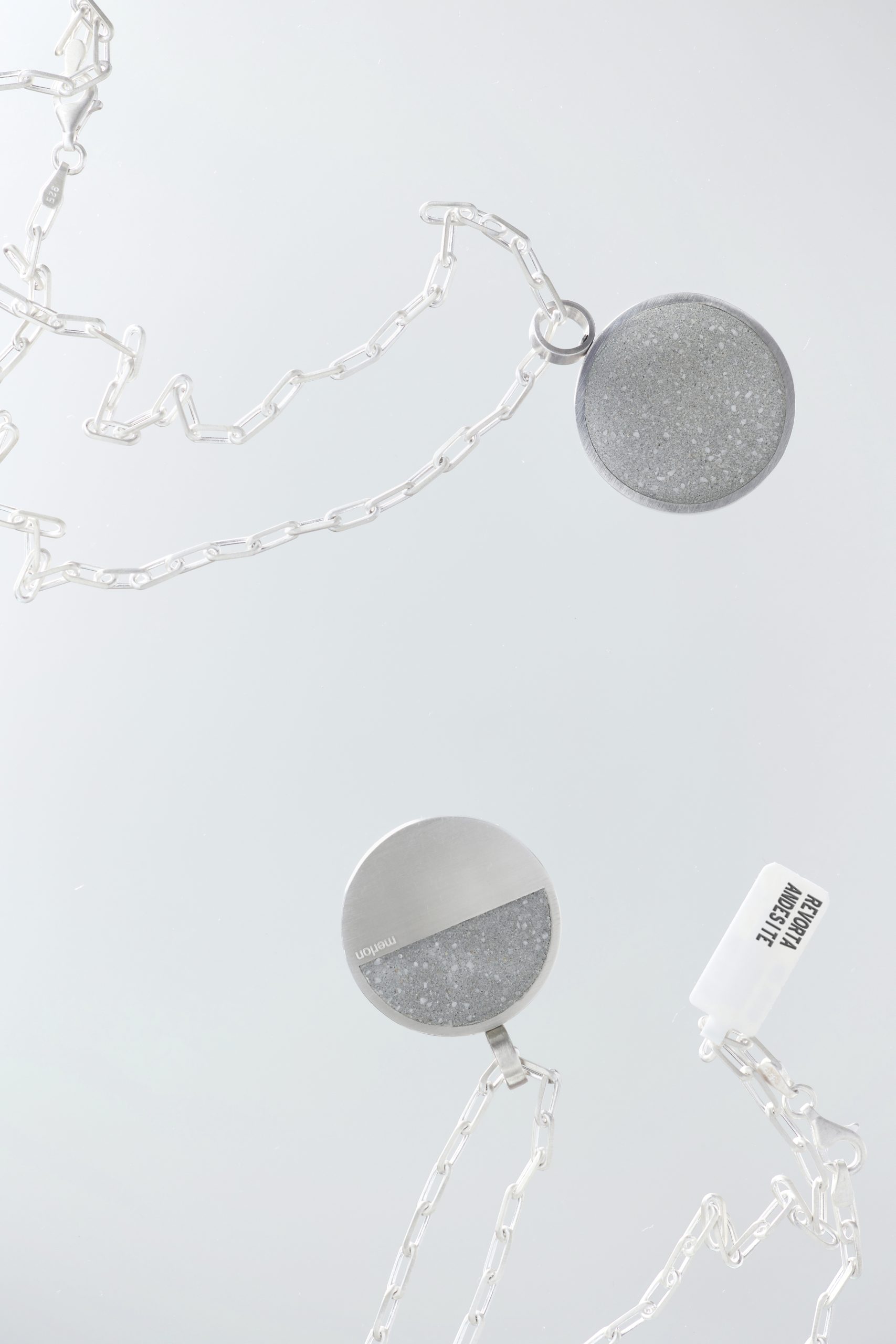 Revorta necklace – handcrafted concrete and silver minimalist architectural jewelry.