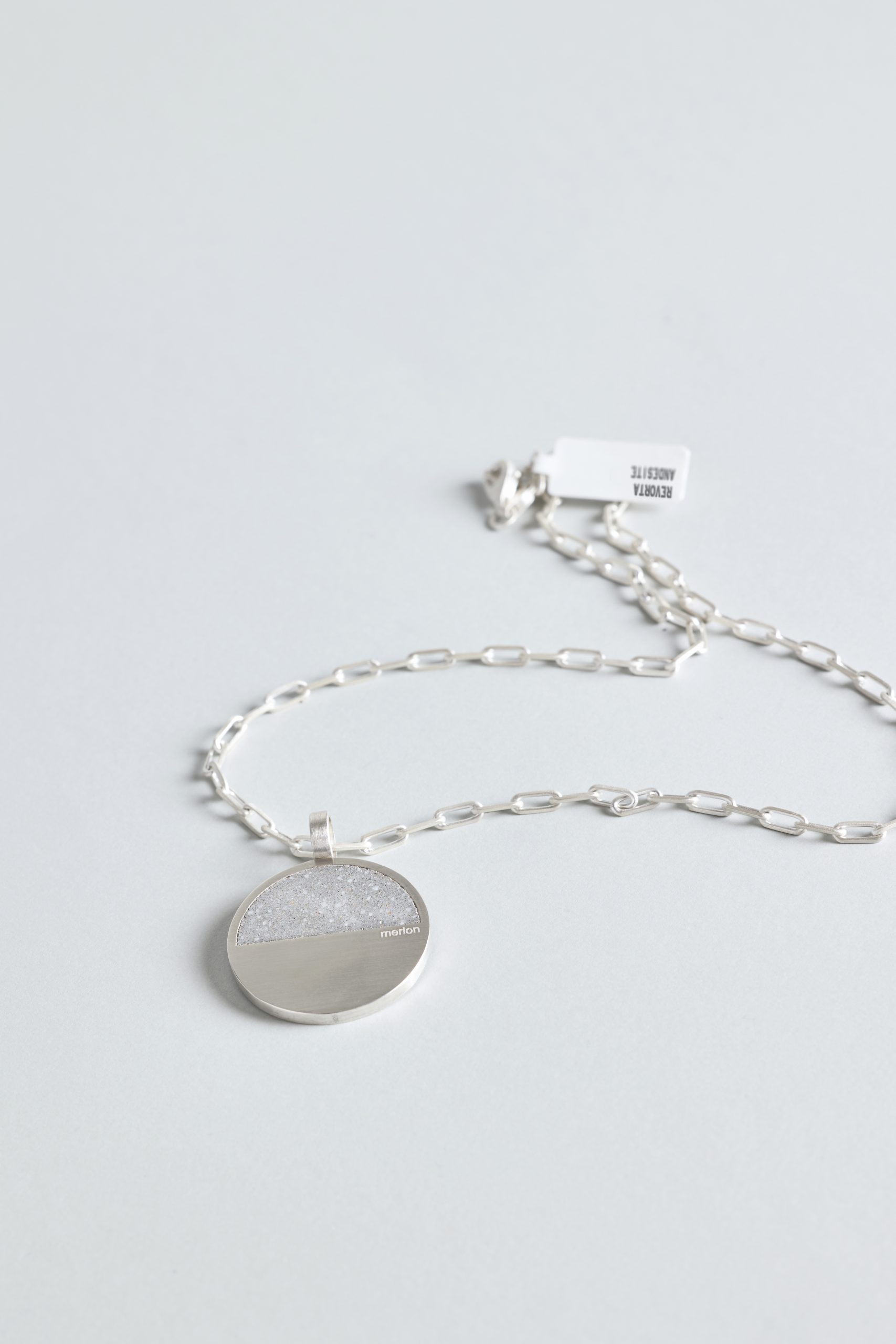Revorta necklace – handcrafted concrete and silver minimalist architectural jewelry.