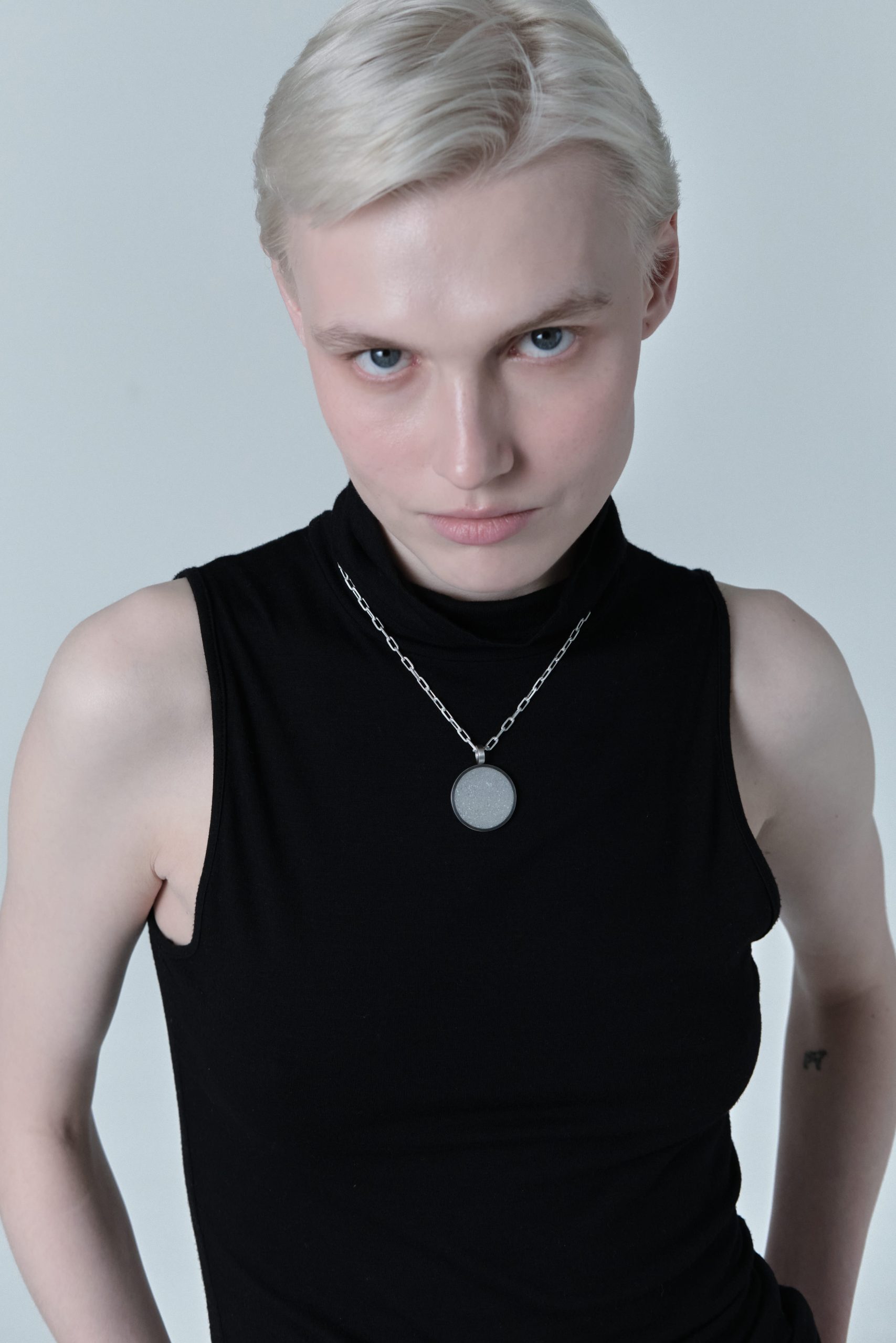 Revorta necklace – handcrafted concrete and silver minimalist architectural jewelry.