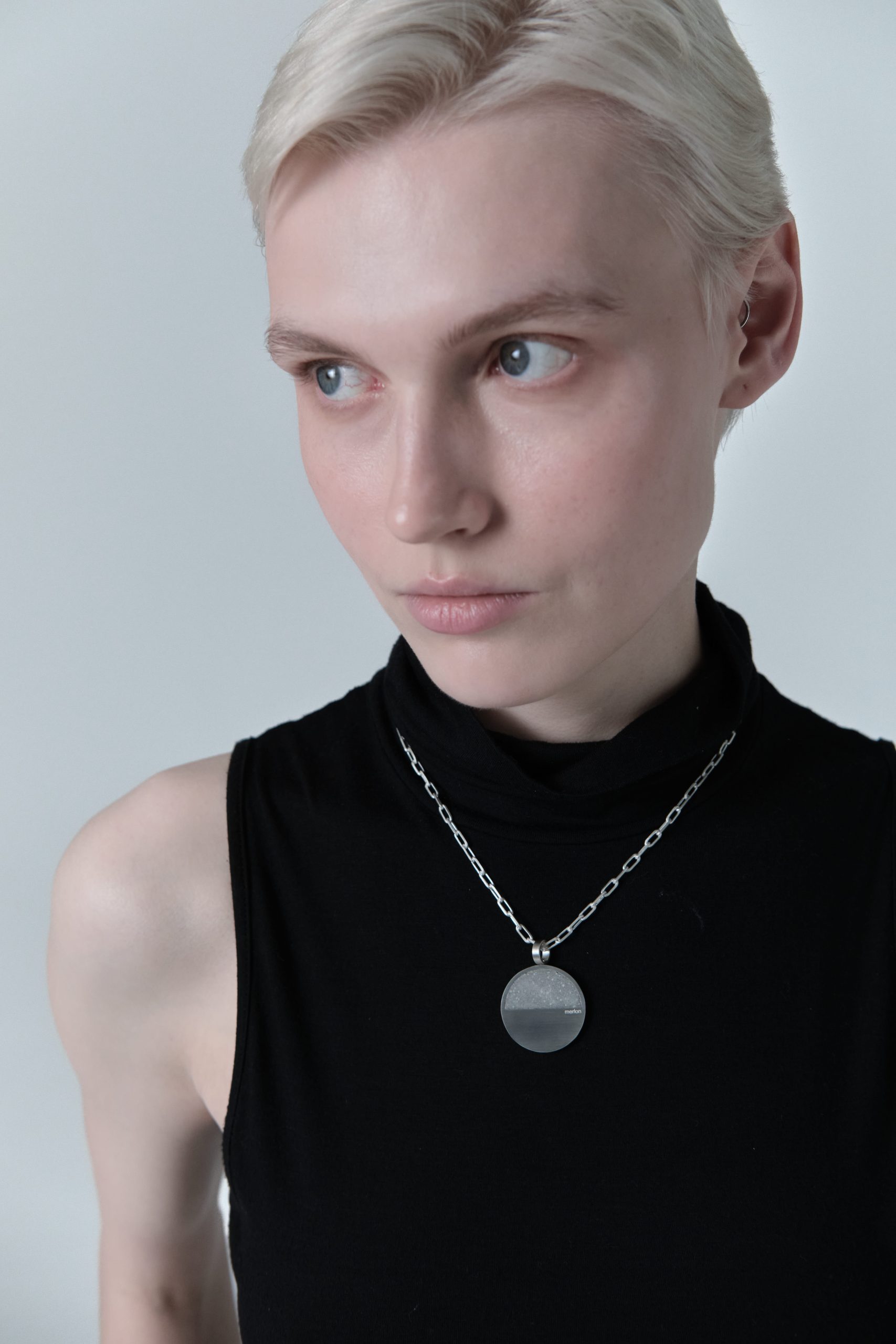 Revorta necklace – handcrafted concrete and silver minimalist architectural jewelry.