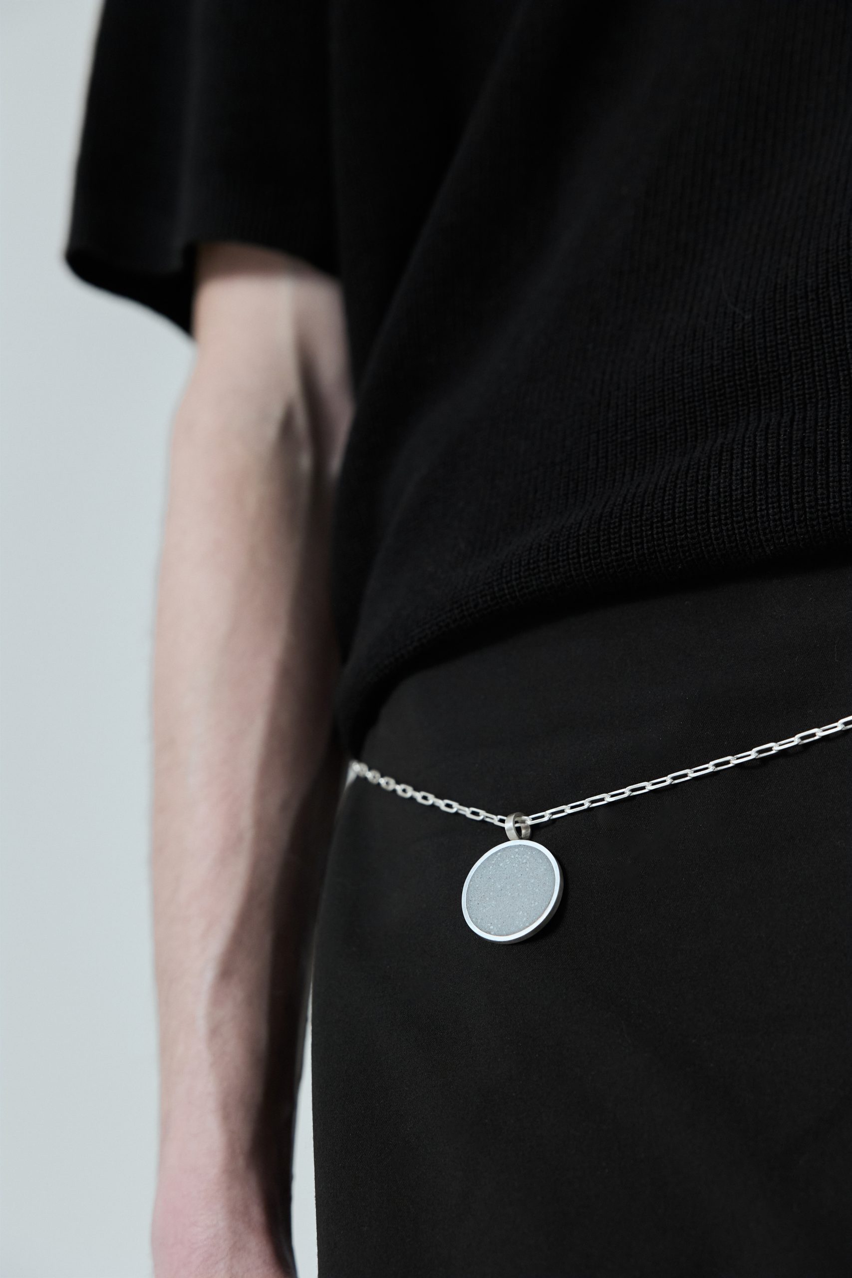Revorta necklace – handcrafted concrete and silver minimalist architectural jewelry.