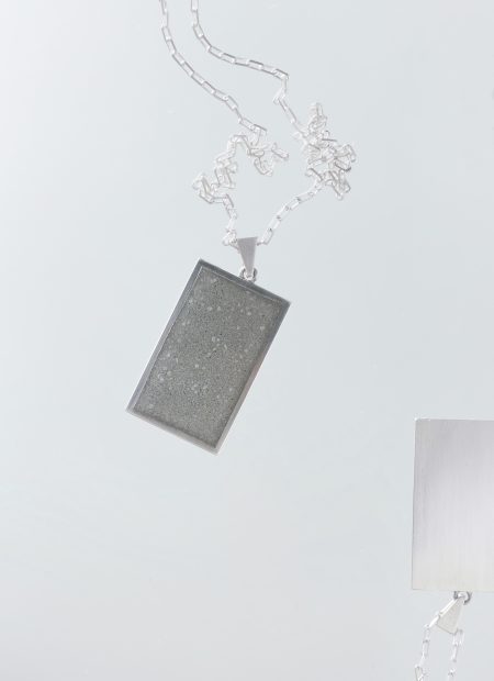Solmant necklace – handcrafted concrete and silver minimalist architectural jewelry.