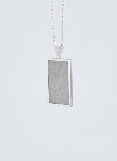 Solmant necklace – handcrafted concrete and silver minimalist architectural jewelry.