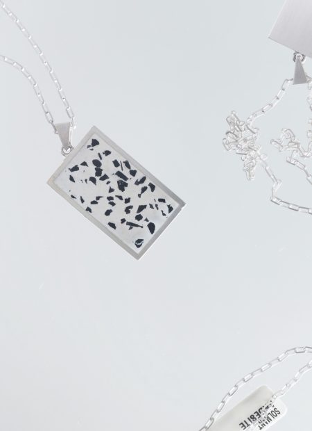 Solmant necklace – handcrafted concrete and silver minimalist architectural jewelry.