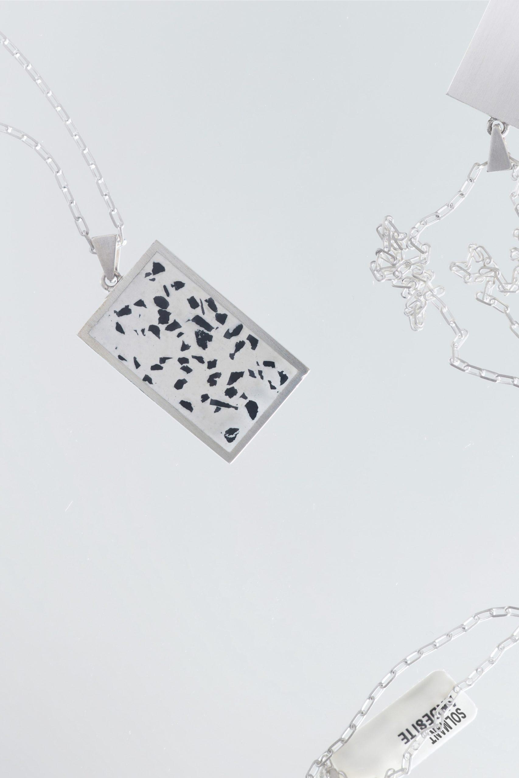 Solmant necklace – handcrafted concrete and silver minimalist architectural jewelry.