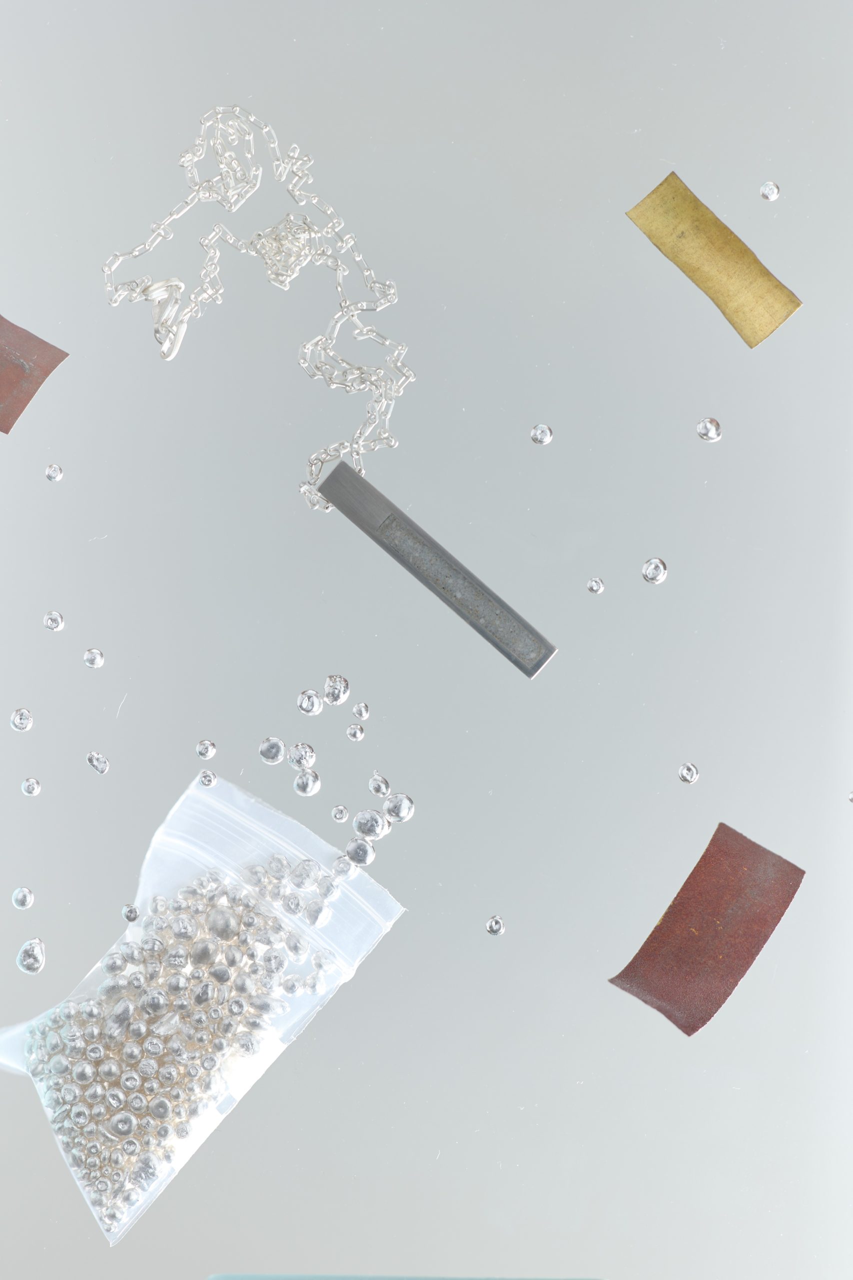 Strund necklace – handcrafted concrete and silver minimalist architectural jewelry.