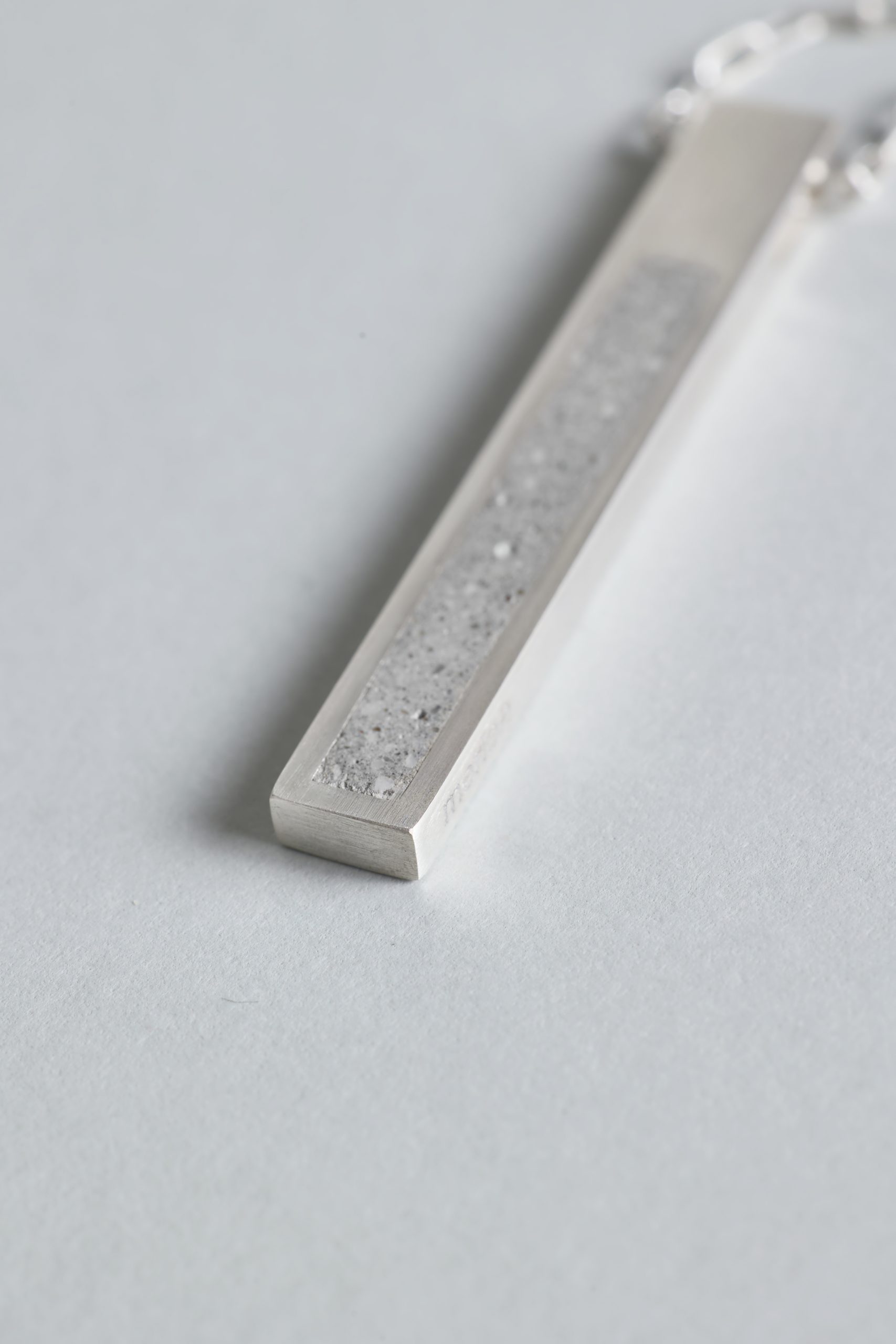 Strund necklace – handcrafted concrete and silver minimalist architectural jewelry.