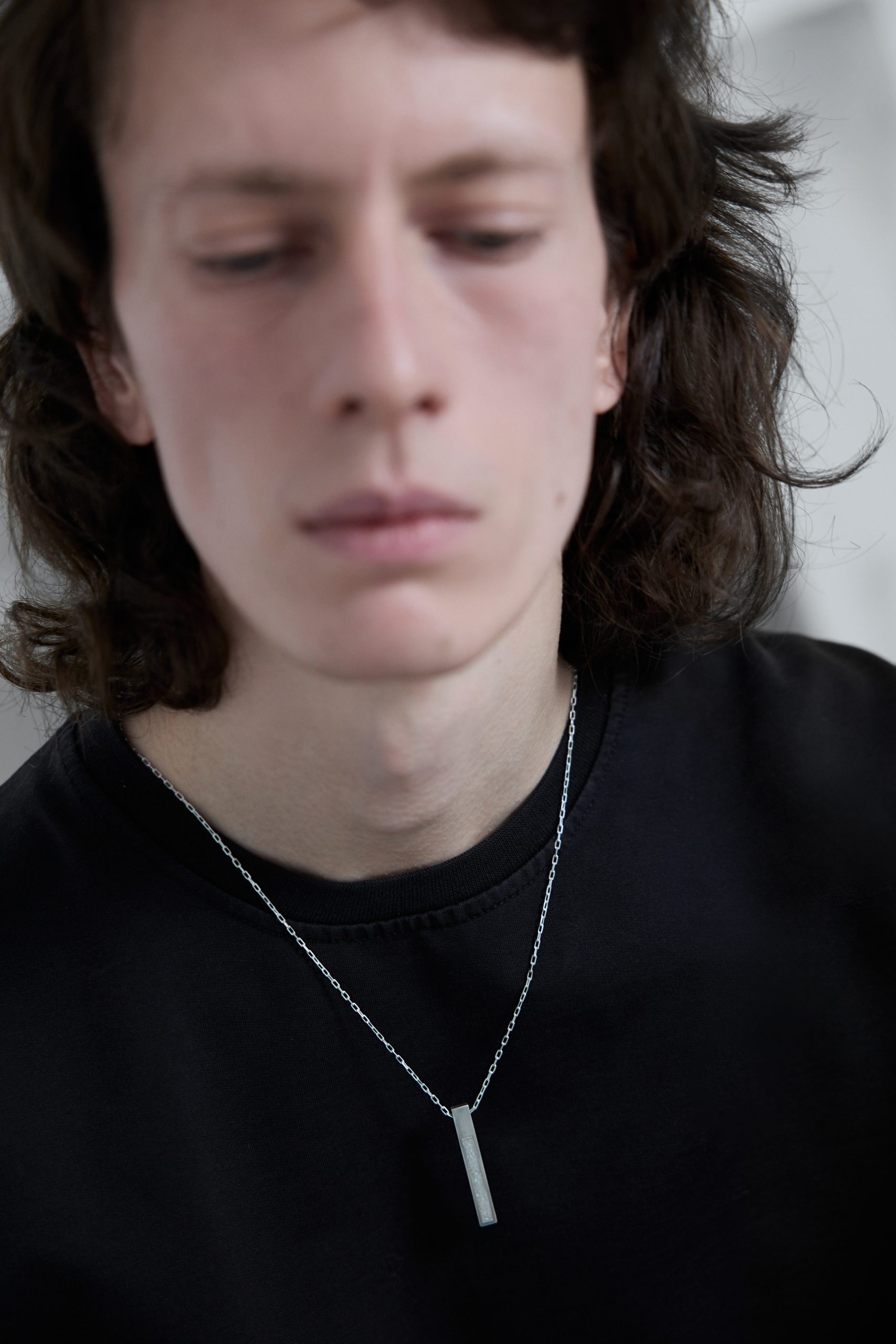 Strund necklace – handcrafted concrete and silver minimalist architectural jewelry.