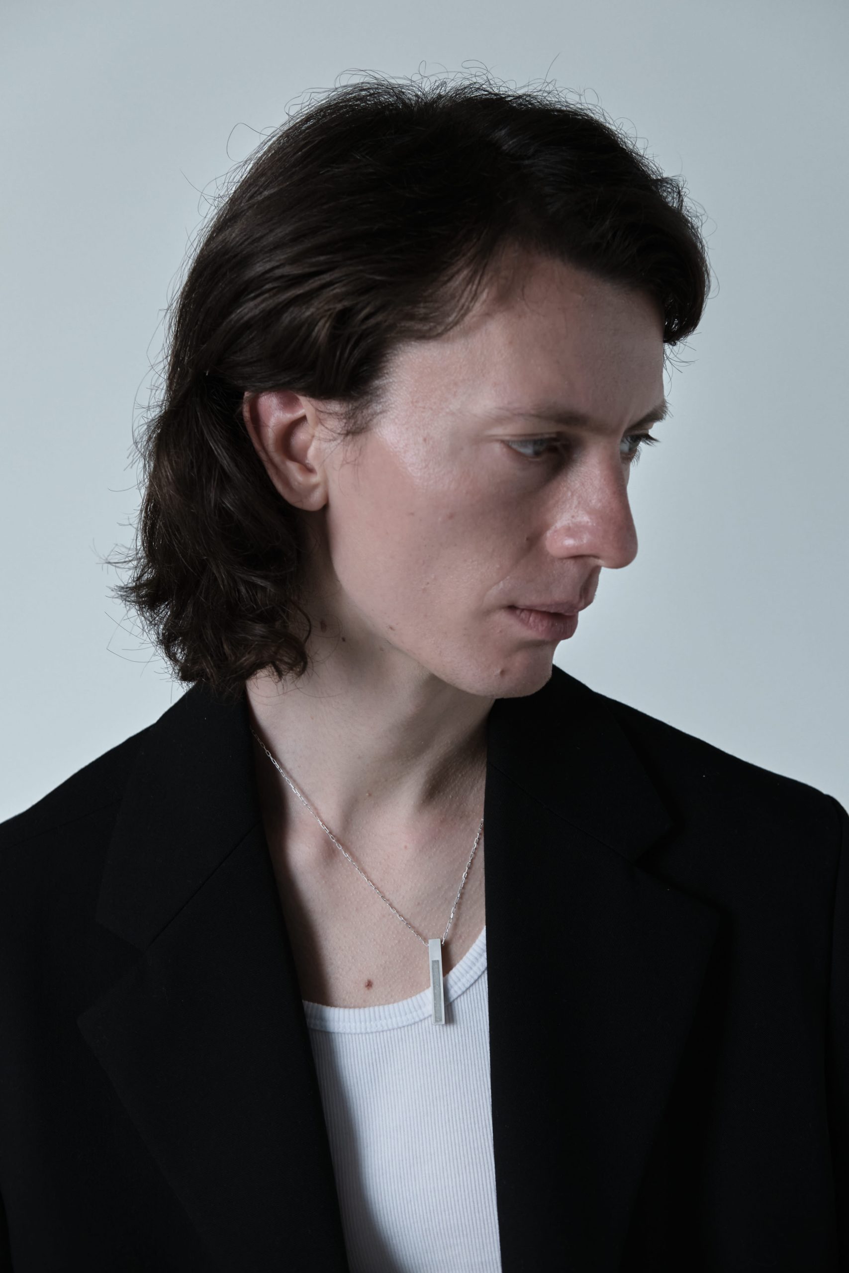 Strund necklace – handcrafted concrete and silver minimalist architectural jewelry.